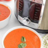 Bowl of creamy copycat Nordstrom tomato basil soup garnished with fresh basil leaves