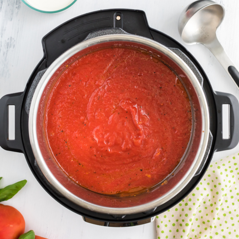 Crushed tomatoes and heavy cream layered over sauteed vegetables in the Instant Pot