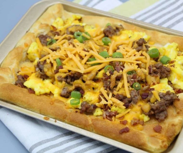 cooked crescent roll breakfast pizza on an air fryer rack