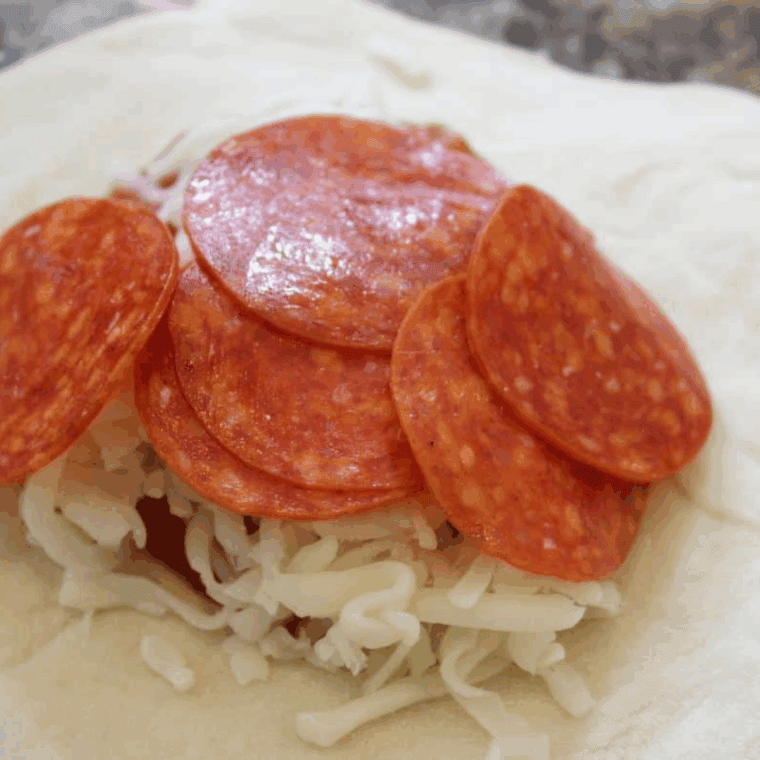add the slices of pepperoni on top.