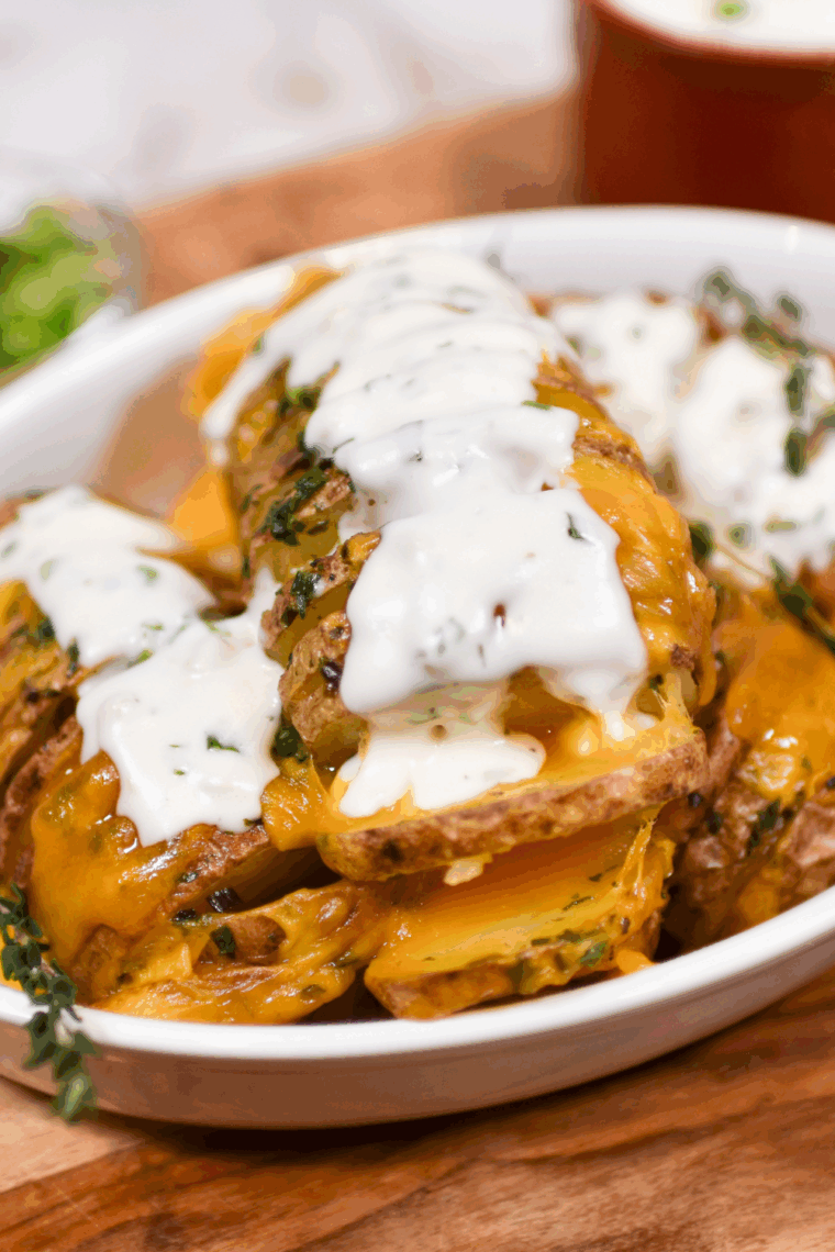 Golden Hasselback potatoes cooked in an air fryer, topped with melted cheese