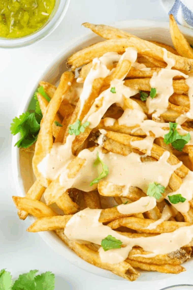 Bowl of creamy Bojangles-style honey mustard sauce with crispy chicken tenders on the side