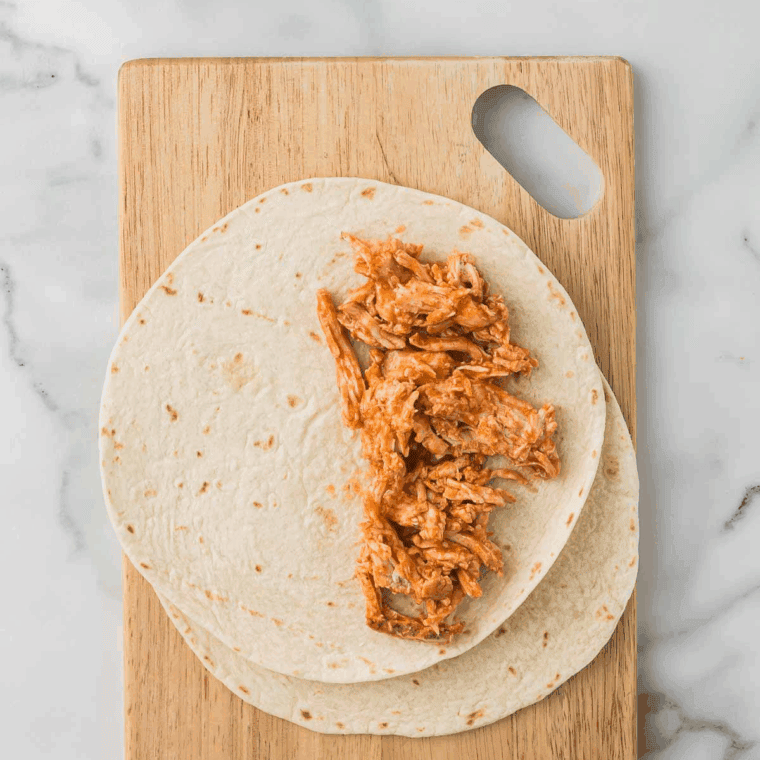 Saut&eacute; shredded chicken in the Instant Pot for 3 minutes, stirring frequently to thicken sauce.