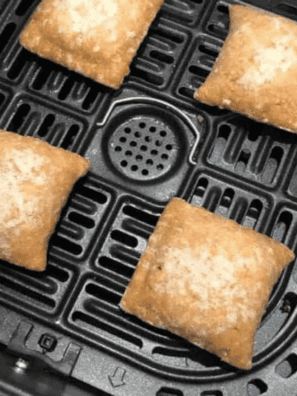 Correctly spaced food in an air fryer basket demonstrating how to use an air fryer