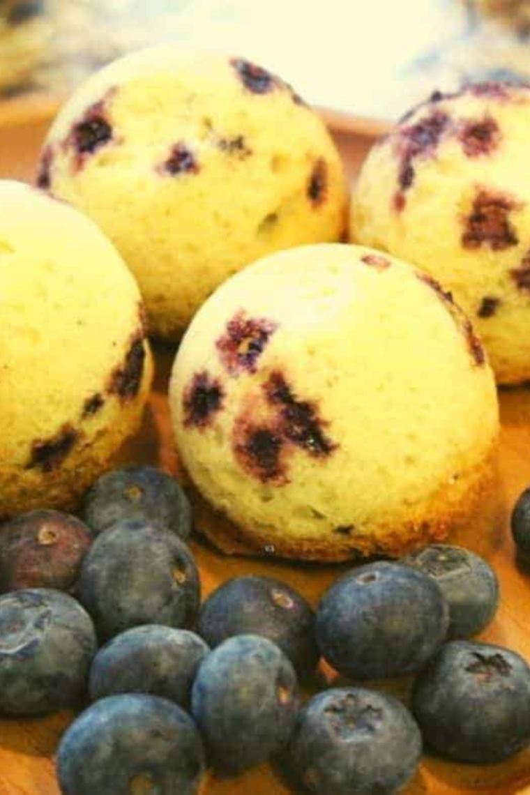 Instant Pot Blueberry Muffins arranged in a stack, emphasizing their light and fluffy texture with visible blueberries.