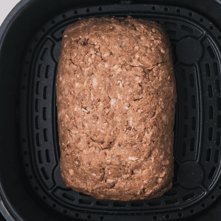 Shaping meatloaf mixture in a loaf pan, baking until cooked through, and resting before slicing for Joanna Gaines meatloaf recipe.