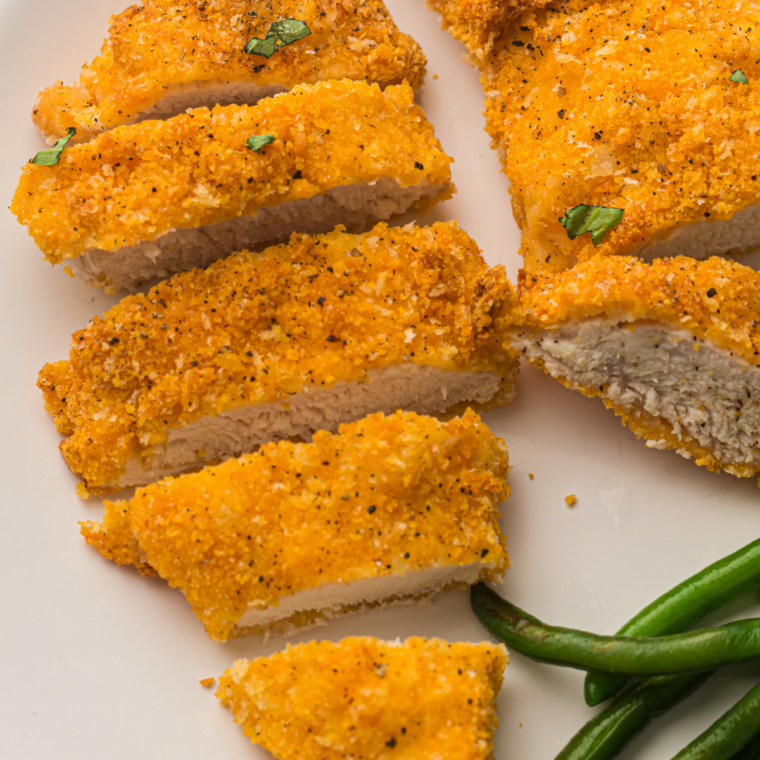 Golden crispy chicken cutlets resting on a plate after air frying, ready to serve juicy and hot.