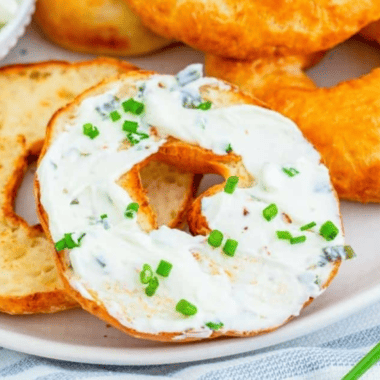 Close up of 2 ingredient bagels topped with cream cheese and chives