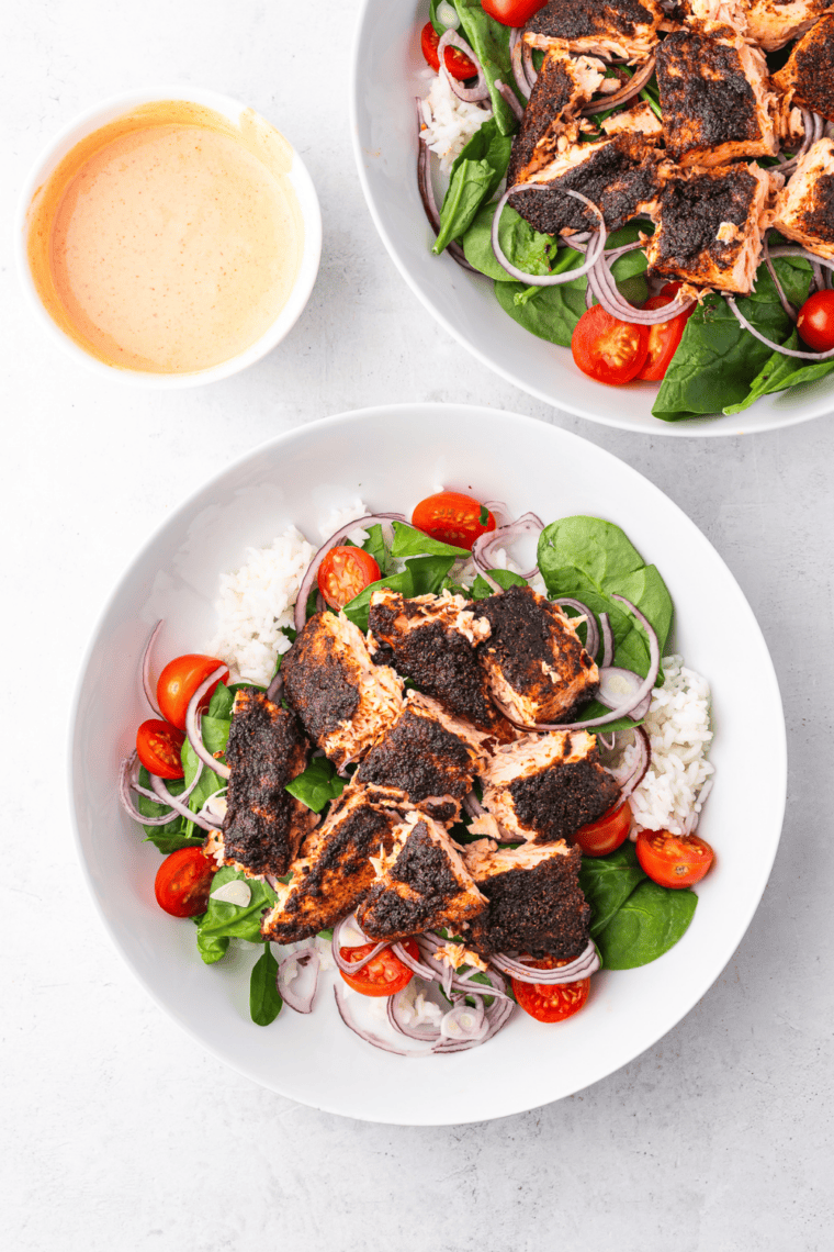 Air fryer blackened salmon on a bed of mixed greens with a light vinaigrette
