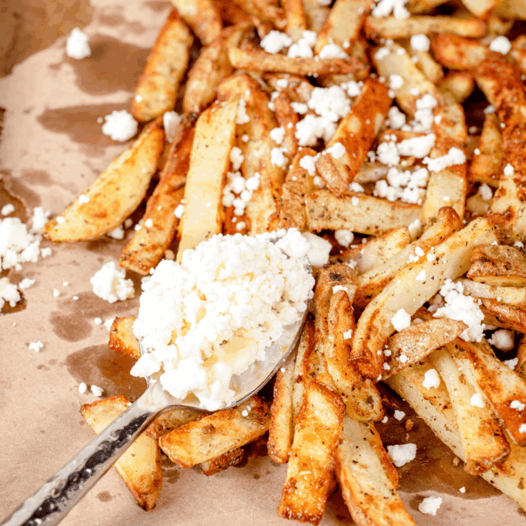Golden, seasoned SmashBurger-style fries in a basket, cooked in the air fryer and ready to serve.