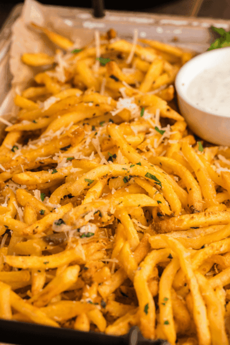 Crispy golden SmashBurger-style fries cooked in an air fryer, served in a basket with seasoning.