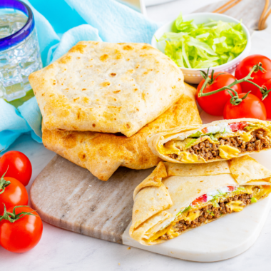 Crispy flour tortilla, seasoned beef, warm nacho cheese, a hidden crunchy tostada shell, lettuce, tomato, and sour cream &mdash; all folded into that famous hexagon shape and air-fried golden in 8 minutes.