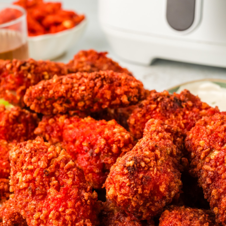 Crispy Air Fryer Flamin’ Hot Chicken Tenders served on a plate with a side of dipping sauce.