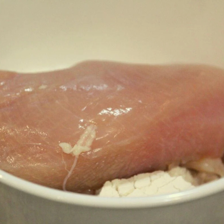 In a large mixing bowl, add your flour, and then add your chicken, coat both sides.