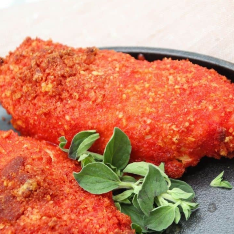 Crispy and spicy Air Fryer Flamin' Hot Chicken Tenders served on a plate with dipping sauce.