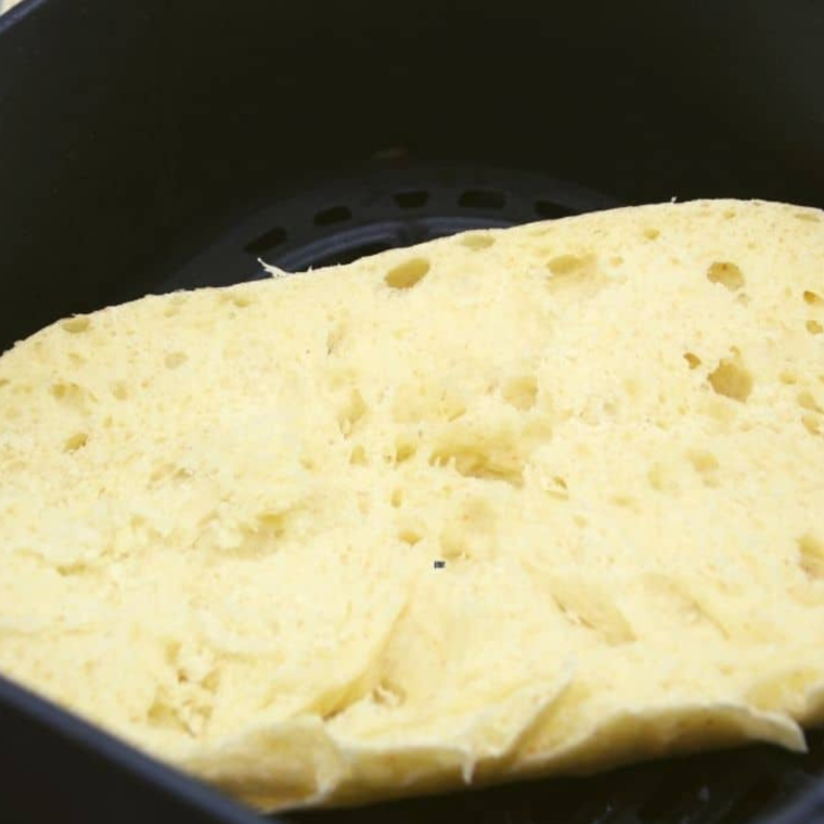 Toast the bread loaf in the air fryer basket.