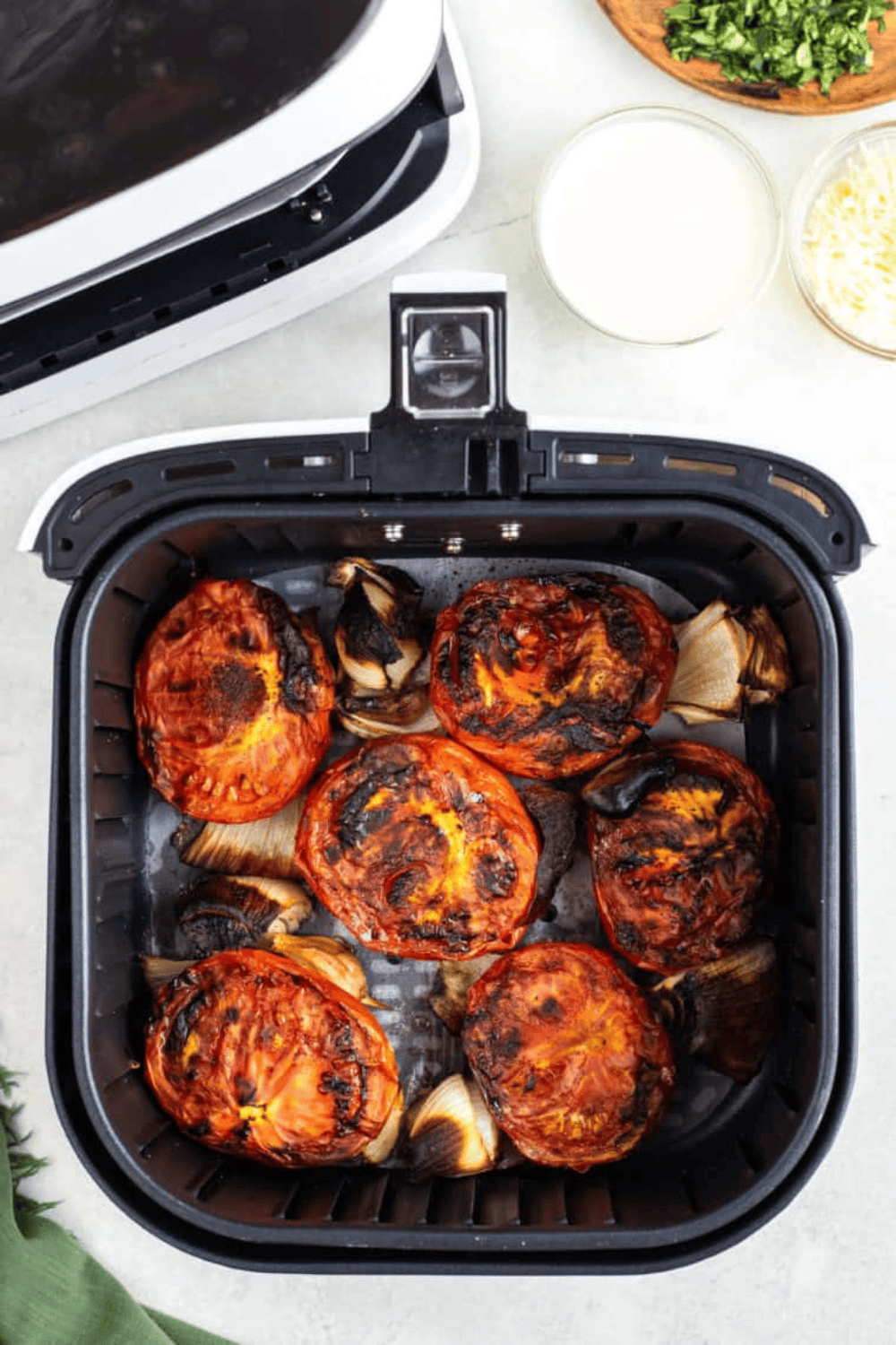 Roasted vegetables in the air fryer basket.
