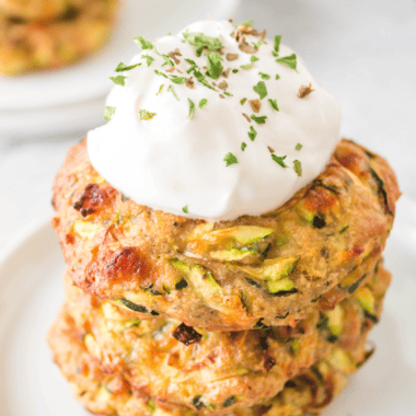 Q: Can I make zucchini fritters without an air fryer? A: Yes, you can. While an air fryer offers a healthier version, you can also pan-fry them in a little oil on the stovetop. Q: How do I prevent my zucchini fritters from falling apart? A: Make sure to squeeze out as much liquid as possible from the grated zucchini. Also, the egg and flour in the mixture act as binders to hold the fritters together. Q: Can I use frozen zucchini for the fritters? A: Fresh zucchini is preferable for texture and flavor. If using frozen, thaw completely and drain all excess water. Q: How do I store leftover zucchini fritters? A: Store them in an airtight container in the refrigerator for up to 3 days. Reheat in the air fryer or oven to maintain crispiness. Q: Can I freeze cooked zucchini fritters? A: Yes, you can freeze them. Place cooled fritters in a single layer on a baking sheet to freeze, then transfer to a freezer bag. Reheat in the air fryer or oven directly from frozen. Q: How long should I cook the fritters in the air fryer? A: Cook time can vary depending on the air fryer model, but it's generally around 10-15 minutes at 375°F, flipping halfway through. Q: Can I make these fritters gluten-free? A: Absolutely. Use a gluten-free flour blend in place of regular flour. Q: What other vegetables can I add to the fritters? A: Carrots, corn, and bell peppers are great additions. Just ensure any added vegetables are finely chopped or grated. Q: Are air fryer zucchini fritters healthy? A: Yes, they are a healthier alternative to traditional fried fritters as they require significantly less oil. Q: What sauces or dips go well with zucchini fritters? A: Tzatziki, sour cream, ranch, or spicy aioli all make excellent choices for dipping.