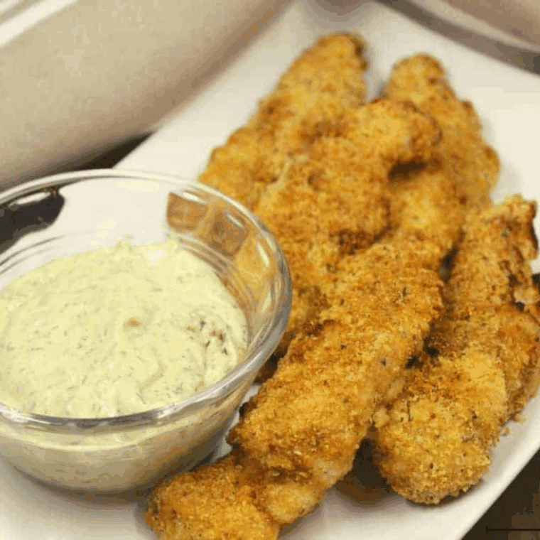 Crispy golden Captain D’s style fish sticks served with tartar sauce and lemon wedges.