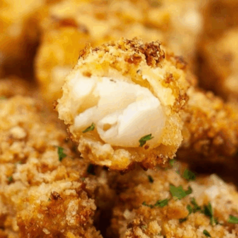 Golden, crispy Captain D’s style fish sticks served with tartar sauce and lemon wedges.