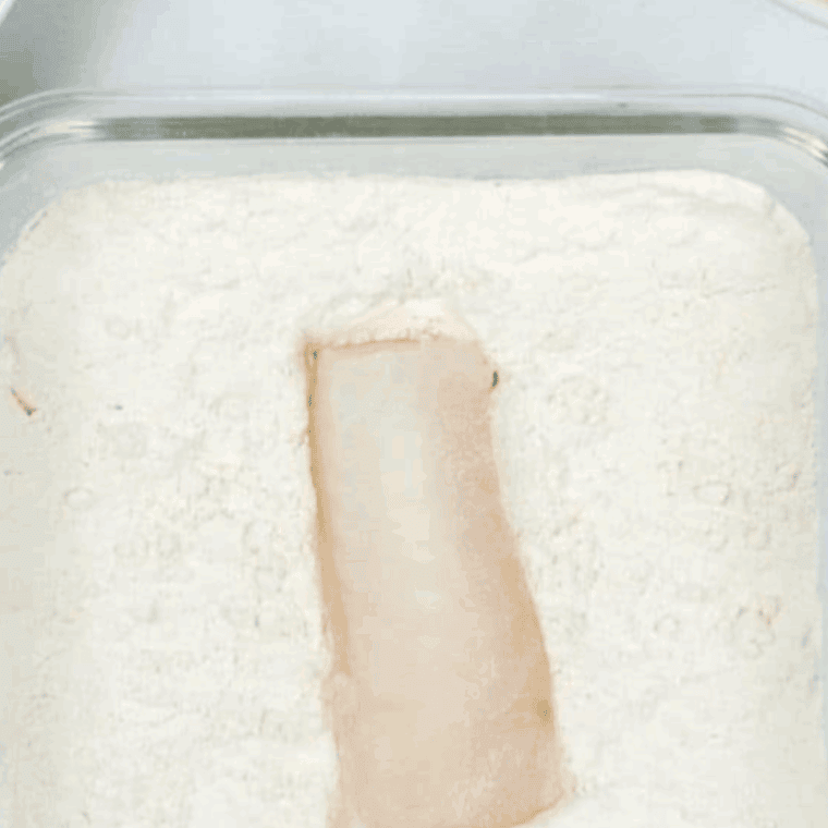 Dredge the fish in the flour mixture.