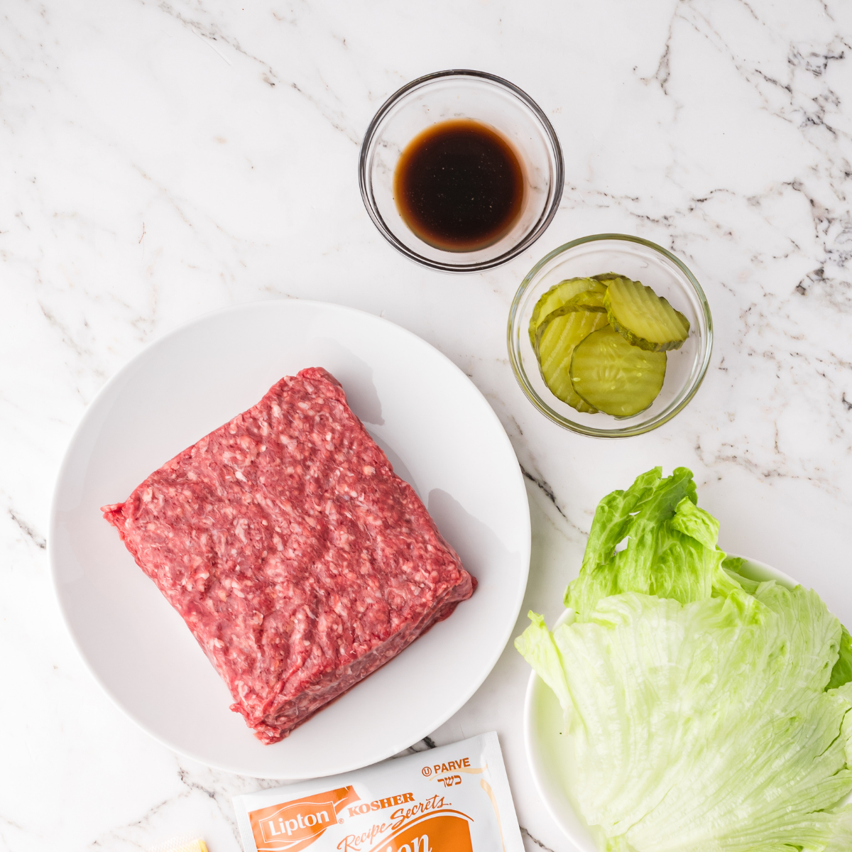 Ingredients needed for Cheesecake Factory Copycat Cheeseburger Egg Rolls on kitchen table.
