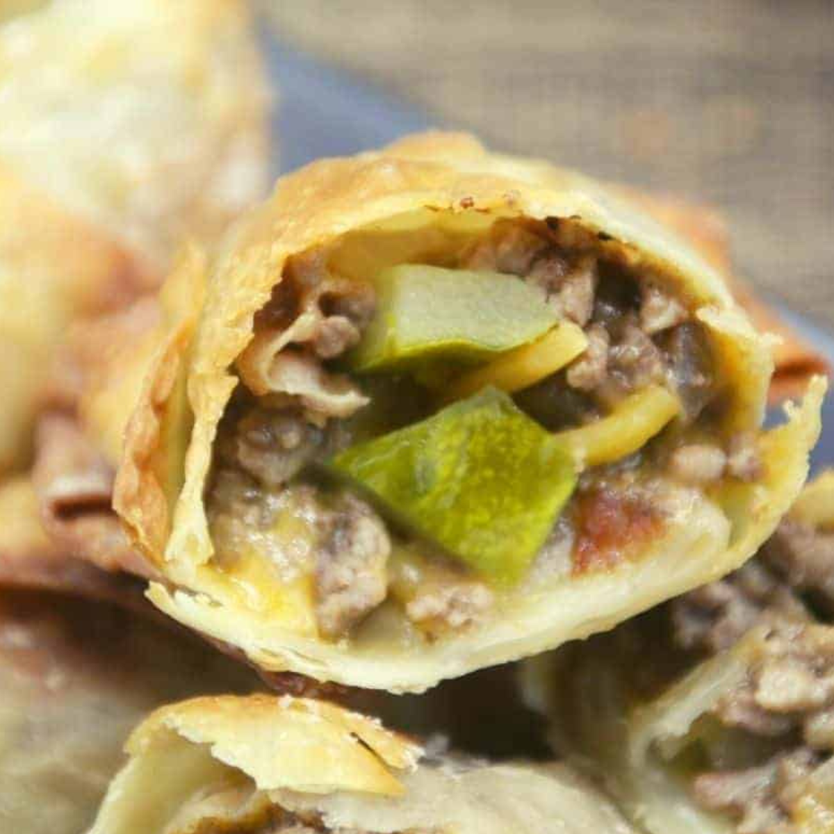 Cheesecake Factory Copycat Cheeseburger Egg Rolls with a crispy golden exterior and savory cheeseburger filling.