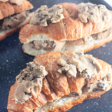 1. Chocolate chip cookie croissants baked golden brown on a parchment-lined baking sheet