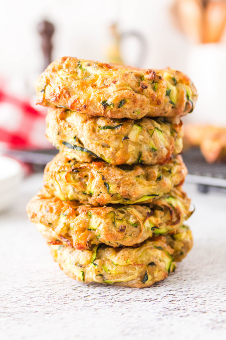 crispy air fryer zucchini fritters golden brown patties on plate