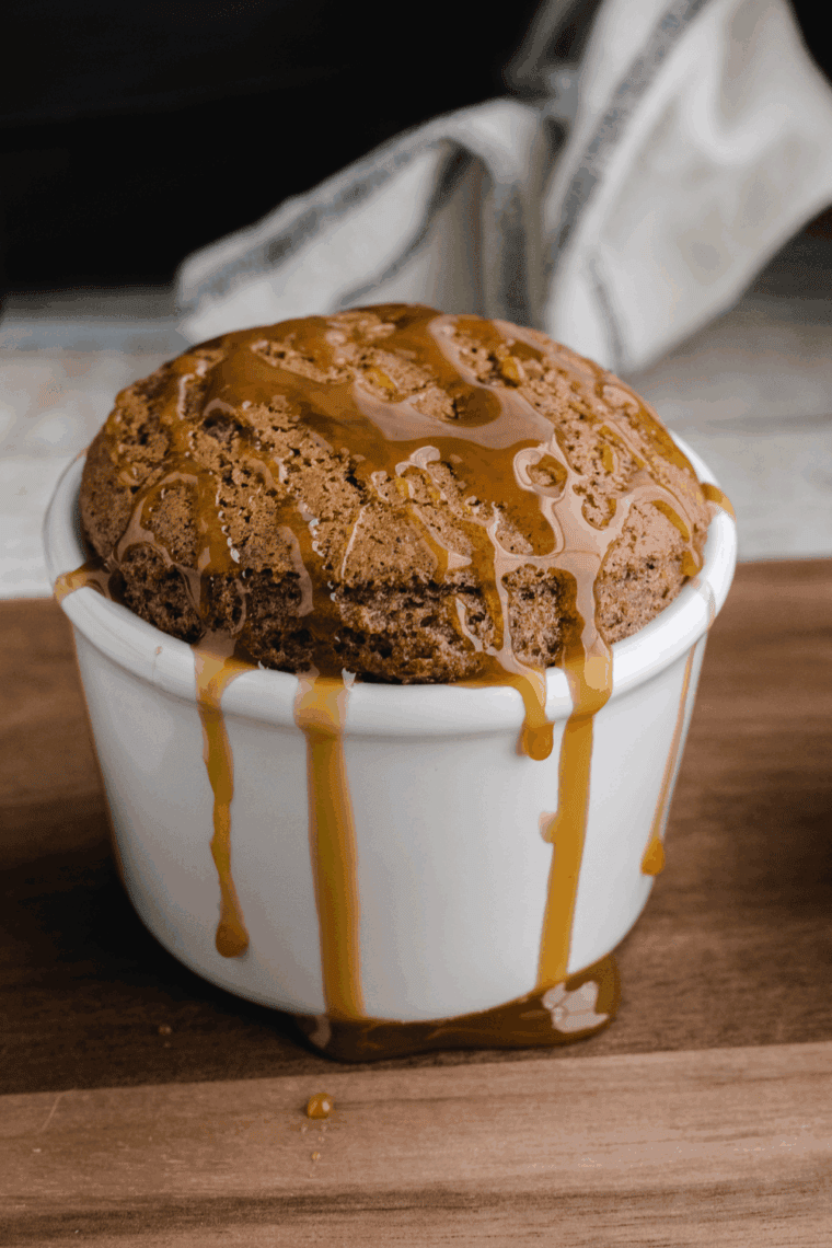 Air fryer apple pie mug cake in a ramekin topped with cinnamon apples