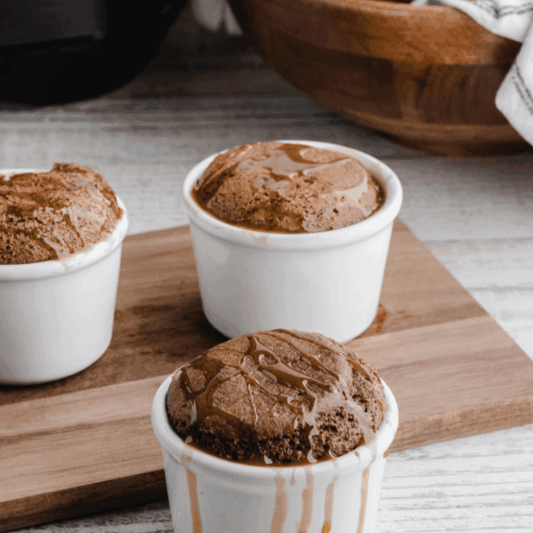 Air fryer apple pie mug cake in a ramekin topped with cinnamon apples