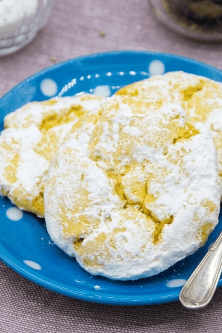 Golden lemon cake mix cookies fresh from the air fryer, soft, chewy, and coated with powdered sugar.