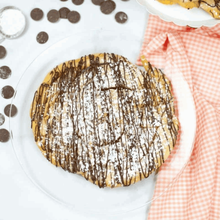 Golden, crispy Instant Pot Funnel Cakes dusted with powdered sugar, ready to enjoy as a delicious homemade snack or dessert.
