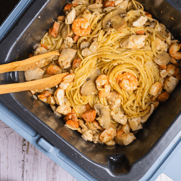 Fettuccine pasta coated in rich alfredo sauce with chicken pieces and parsley.