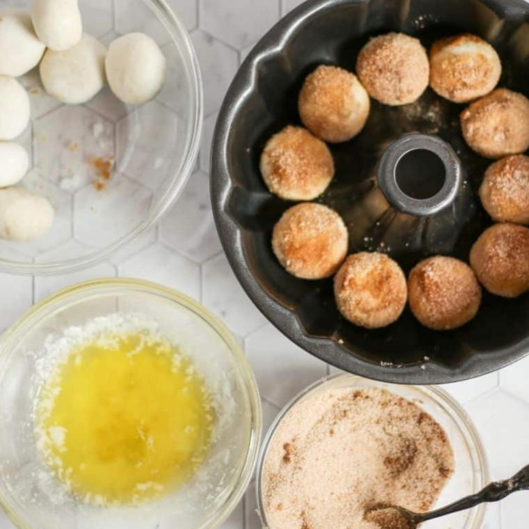 "Mixing granulated sugar and ground cinnamon in a bowl"