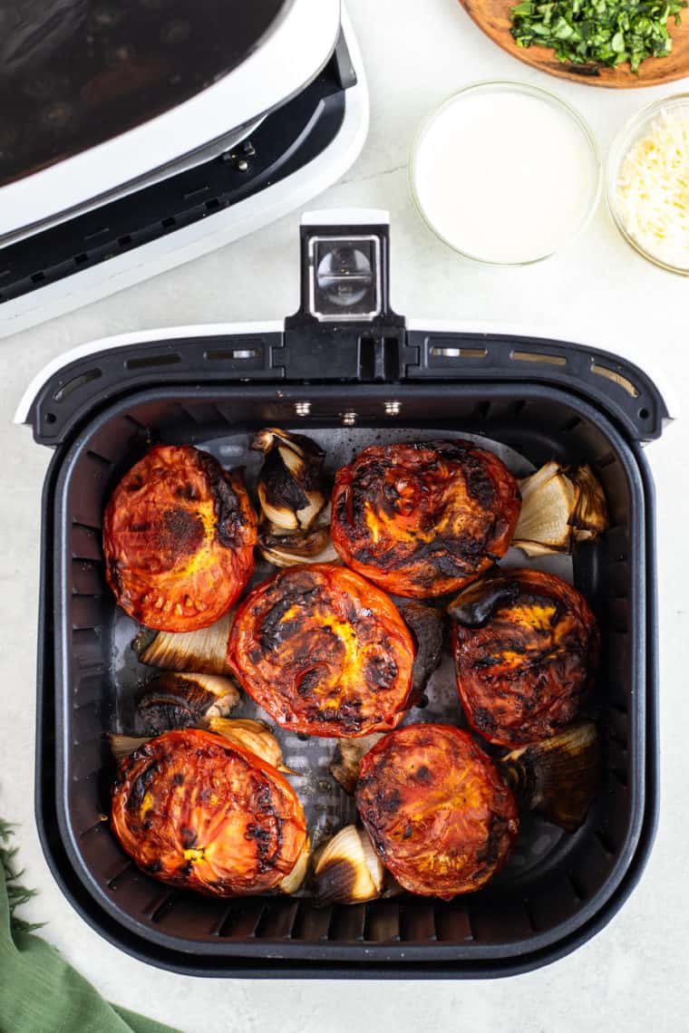 overhead: roasted tomatoes and onion to make salsa in air fryer