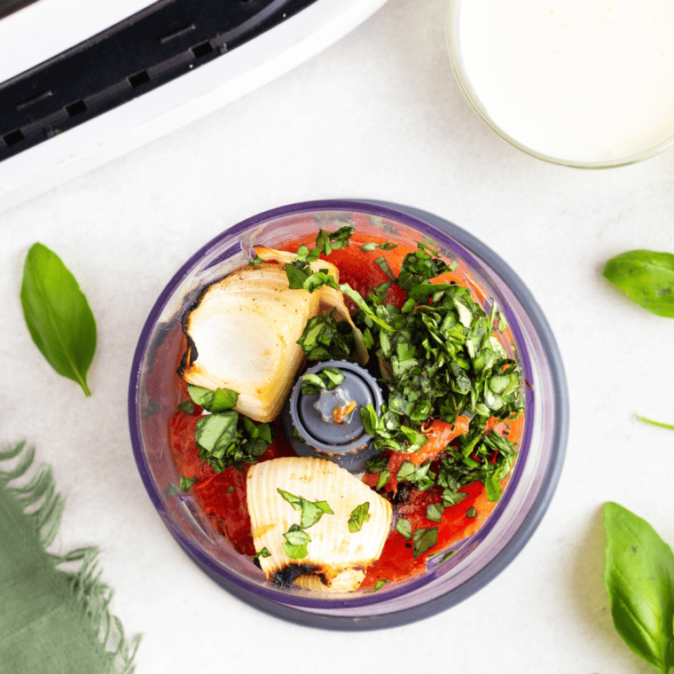 overhead: roasted vegetables and fresh herbs in food processor to make salsa in air fryer