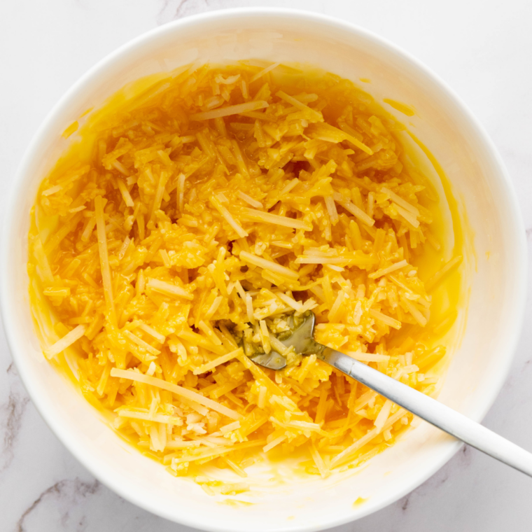 Mix eggs and yogurt: Whisking eggs, fat-free yogurt, grated Parmesan, and black pepper in a bowl.