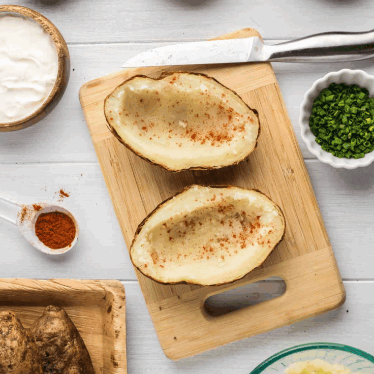 Using a spoon remove the insides of the potato, to make room for the filling.