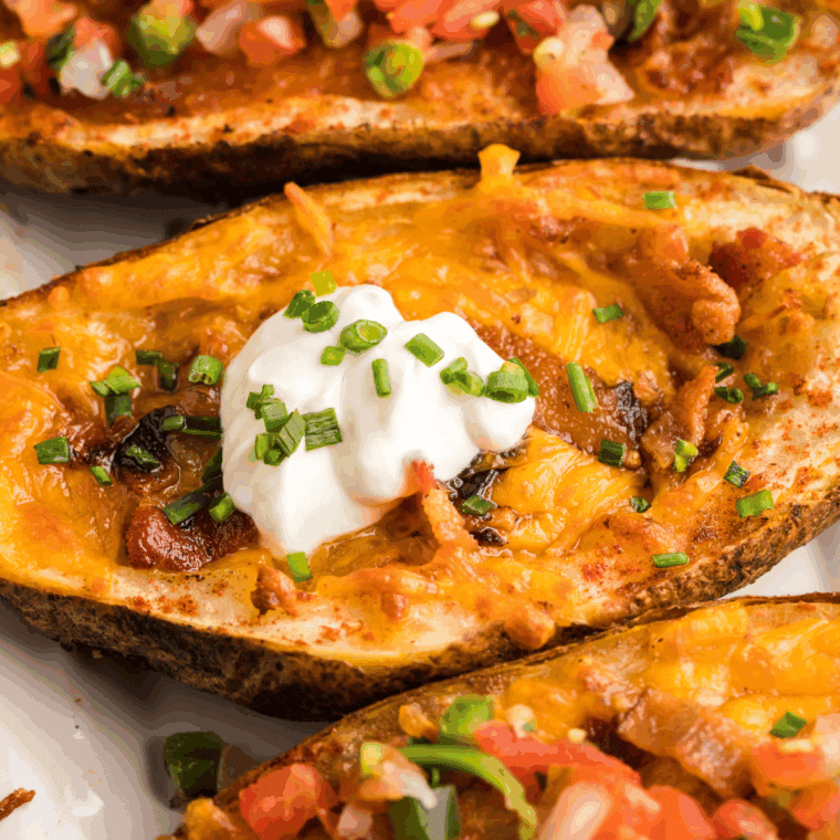 Crispy homemade Texas Roadhouse-style tater skins topped with melted cheese, bacon, and green onions.