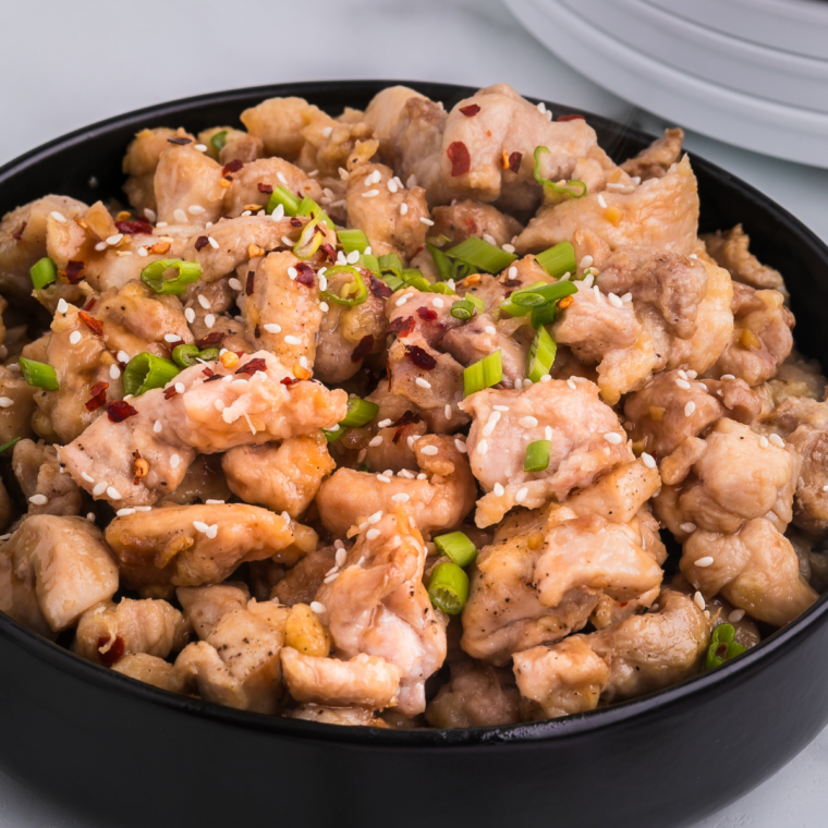 Air Fryer Bourbon Chicken pieces in a bowl, glistening with a rich bourbon sauce.