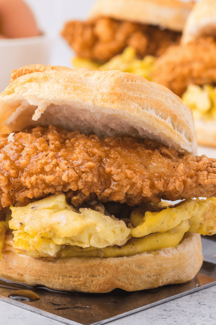 Freshly cooked air fryer canned biscuits with golden tops and soft fluffy centers inside an air fryer basket.