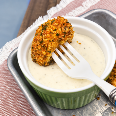 Air fryer Doritos fried pickles on a platter with ranch for dipping