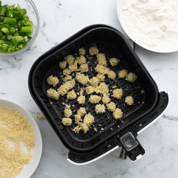 Spraying air fryer basket with cooking spray and placing breaded okra inside; setting air fryer to 375°F and cooking for 10-12 minutes, shaking basket occasionally.