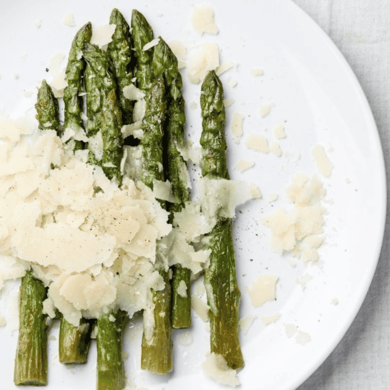 Air fryer basket with frozen asparagus cooked to crispy perfection.