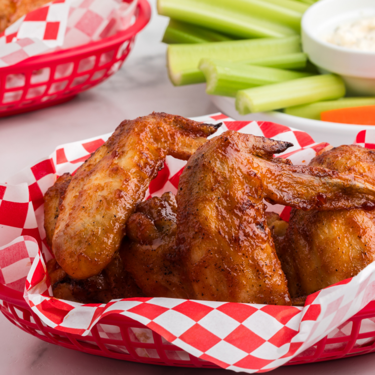 Close-up of crispy air fryer chicken wings tossed in honey BBQ sauce.