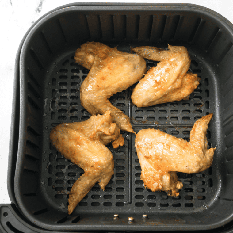 Honey Garlic Chicken Wings in air fryer basket.