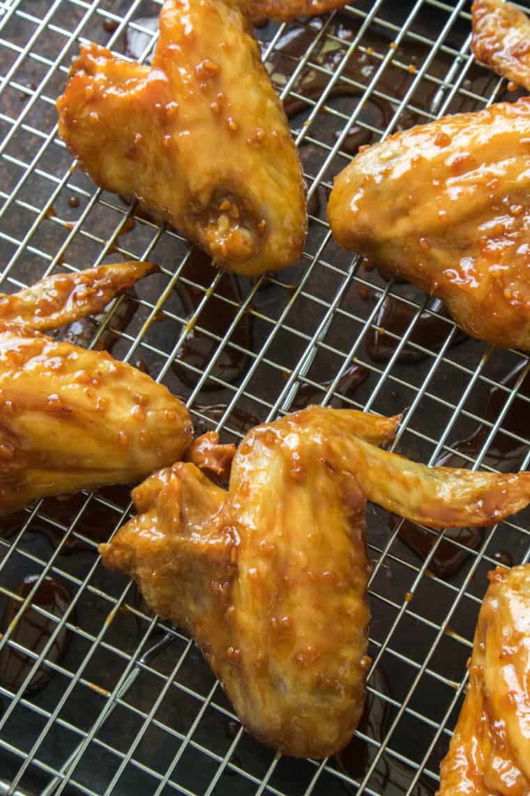 Air Fryer Honey Garlic Chicken Wings on tray, after being coated with the marinade.