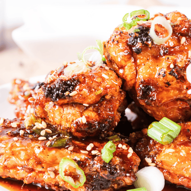 Plate of air fryer Jack Daniel's wings glazed in sticky whiskey BBQ sauce