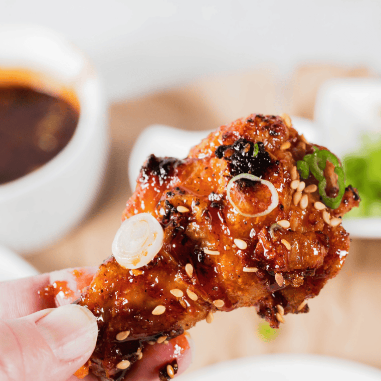 Close-up of a sticky air fryer Jack Daniel's wing glazed in whiskey BBQ sauce